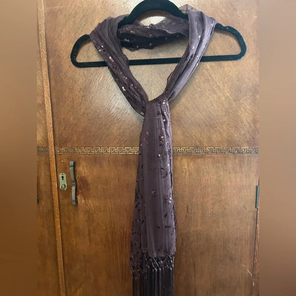 Sheer sequin embellished evening shawl or wrap with fringe tassels. Wine color